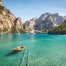 Calendar day 19: rowing boats on a turquoise alpine lake below rocky peaks