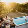Entry thumbnail: friends around a pool at sunset under strings of festoon lights